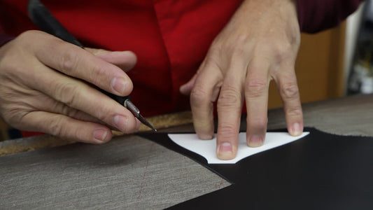 Hands cutting leather by hand in a Brazilian shoe atelier