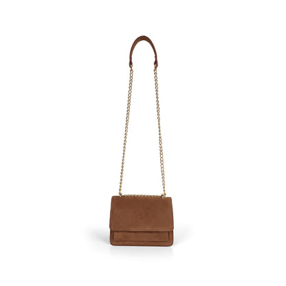 Blair cognac suede bag hanging from its gold-tone chain strap